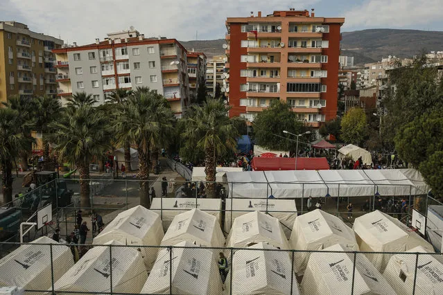 Tents set up for homeless people are placed on a basketball court in Izmir, Turkey, Monday, November 2, 2020. Rescue teams continue ploughing through concrete blocs and debris of collapsed buildings in Turkey's third largest city in search of survivors of a powerful earthquake that struck Turkey's Aegean coast and north of the Greek island of Samos, Friday Oct. 30, killing dozens. Close to a thousand people were injured. (Photo by Emrah Gurel/AP Photo)