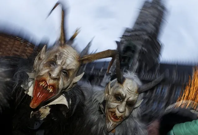 Men dressed as “Krampus” creatures take part in a parade at Munich's Christmas market, December 14, 2014. (Photo by Michaela Rehle/Reuters)