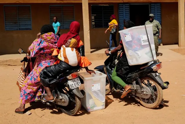 Electoral workers transport ballot boxes on their motorcycles as they arrive to prepare a polling station ahead of the presidential and legislative elections, in Ouagadougou, Burkina Faso, November 21, 2020. (Photo by Zohra Bensemra/Reuters)