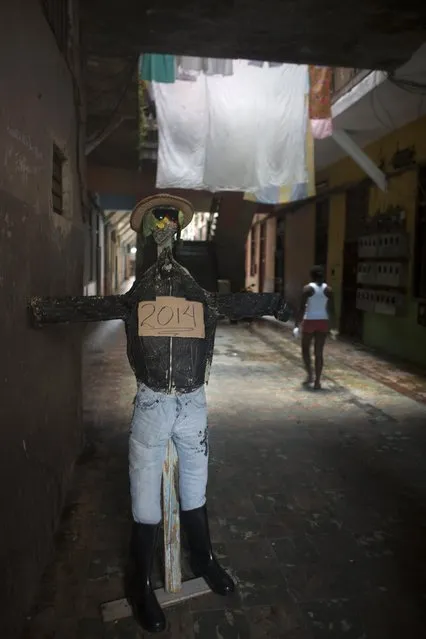 An effigy symbolising the year 2014 is seen at the entrance of a residential building in downtown Havana, December 29, 2014. The effigy will be burnt on midnight on December 31 as a way of welcoming the new year. (Photo by Alexandre Meneghini/Reuters)