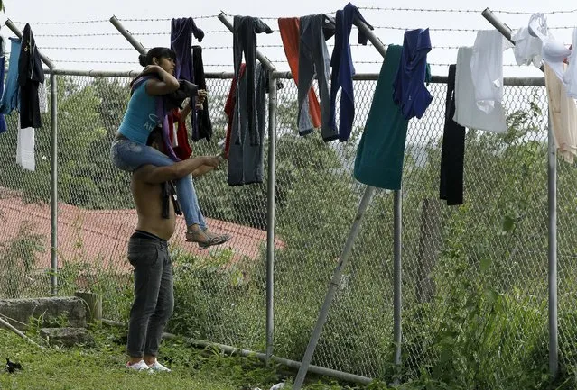 Cubans migrants try their clothes at a temporary shelters in a school in the town of La Cruz near the border between Costa Rica and Nicaragua, November 16, 2015. Nicaragua on Sunday closed its border with Costa Rica to hundreds of Cubans headed for the United States, stoking diplomatic tensions over a growing wave of migrants making the journey north from the Communist-ruled island. (Photo by Juan Carlos Ulate/Reuters)