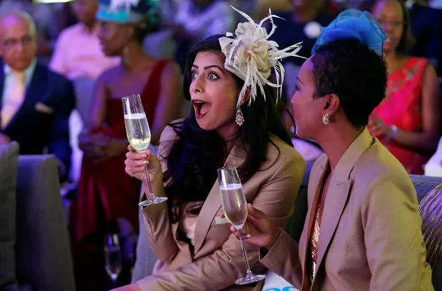 Pinky Ghelani and Suzzy Wokabi watch a TV broadcast of Britain's Prince Harry and Meghan Markle's royal wedding at the Windsor golf and country club in Nairobi, Kenya May 19, 2018. (Photo by Thomas Mukoya/Reuters)