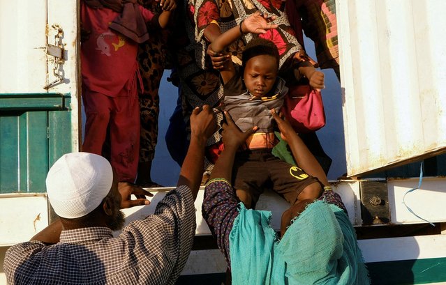A displaced boy from al-Fashir is helped down from a truck, at a displacement camp in Al-Dabba, Sudan, on November 19, 2025. (Photo by El Tayeb Siddig/Reuters)