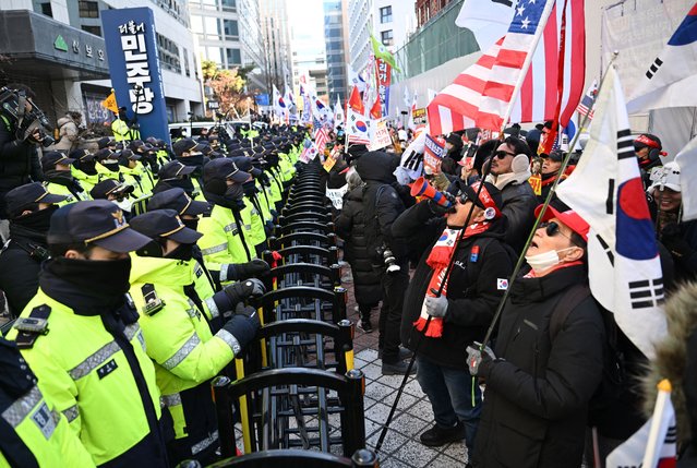 Supporters of South Korea's ousted president Yoon Suk Yeol shout slogans in front of the ruling Democratic Party headquarters during a rally marking the first anniversary of Yoon's declaration of martial law, near the National Assembly in Seoul on December 3, 2025. South Korea's ousted former leader Yoon Suk Yeol issued a call from prison on December 3 urging his supporters to rally for “freedom” and defending his decision to declare martial law a year ago. (Photo by Jung Yeon-je/AFP Photo)
