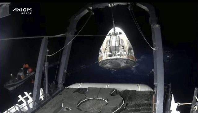 In this frame grab from video broadcast by SpaceX, recovery crews lift and secure the SpaceX Dragon capsule after it splashed down into the Gulf of Mexico, just off the Florida Panhandle, late Tuesday, May 30, 2023. The private flight carrying two Saudi astronauts and other passengers returned to Earth after a nine-day trip to the International Space Station. (Photo by SpaceX via AP Photo)