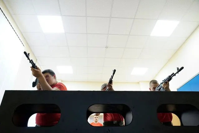 Teenagers undergo a weapons handling training at an Avangard military-patriotic educational camp in the southern Rostov region on June 9, 2023. (Photo by AFP Photo/Stringer)