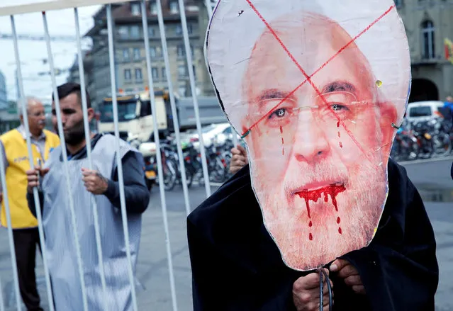 People demonstrate against the official visit of Iranian President Hassan Rouhani in Bern, Switzerland, July 3, 2018. (Photo by Denis Balibouse/Reuters)