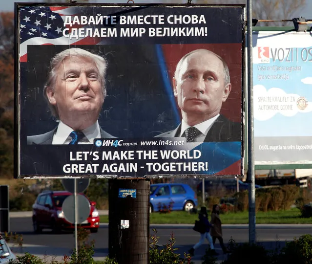 Pedestrians cross the street behind a billboard showing a pictures of  US president-elect Donald Trump and Russian President Vladimir Putin in Danilovgrad, Montenegro, November 16. 2016. (Photo by Stevo Vasiljevic/Reuters)