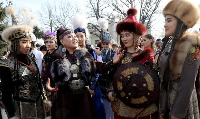 Kyrgyz girls in national costumes take part in the celebration of the White Kalpak Day in the center of Bishkek, Kyrgyzstan on 04 March 2021. Ak Kalpak Day is celebrated in Kyrgyzstan in honor of the national headdress of the Kyrgyz in order to support national traditions and culture. The holiday was officially established on 29 June 2016, but has been celebrated for 10 years. (Photo by Igor Kovalenko/EPA/EFE)