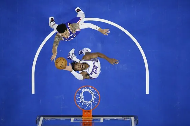 Sacramento Kings' Buddy Hield, bottom leaps for a rebound against Philadelphia 76ers' Danny Green during the first half of an NBA basketball game, Saturday, March 20, 2021, in Philadelphia. (Photo by Matt Slocum/AP Photo)