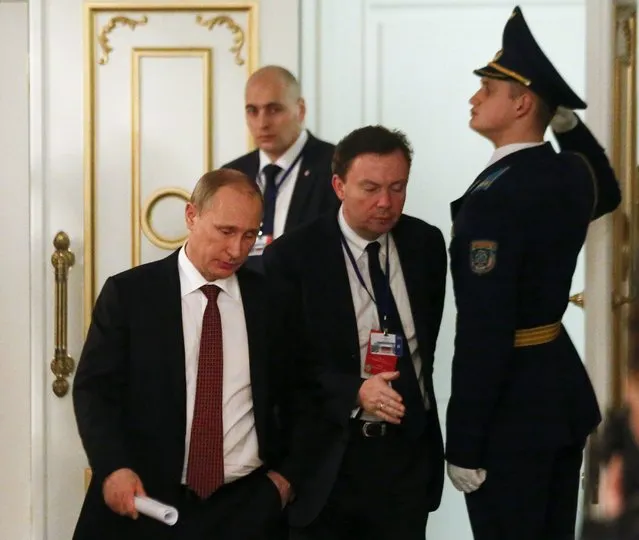 Russia's President Vladimir Putin (L) walks as he attends a peace summit to resolve the Ukrainian crisis in Minsk, February 12, 2015. (Photo by Vasily Fedosenko/Reuters)