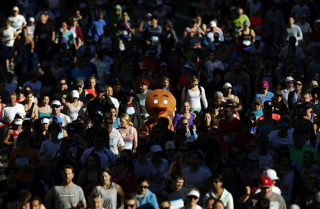 A participant dressed as a gingerbread man races at the annual “City 2 Surf Fun Run” in central Sydney August 11, 2013. According to organizers, more than 85,000 entered the race that covered 14 km (8.7 miles) from Sydney's central business district to Bondi Beach, raising funds for charity. (Photo by Daniel Munoz/Reuters)