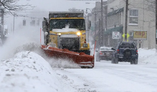 A plows clears a road Monday, February 9, 2015, in Framingham, Mass. (Photo by Bill Sikes/AP Photo)
