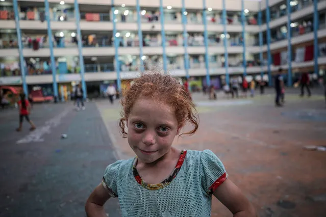 A picture made available on 20 May 2021 shows a Palestinian girl joining her family to take refuge at the United Nations (UN) school, due to the ongoing armed conflicts in Gaza City, 19 May 2021. In response to days of violent confrontations between Israeli security forces and Palestinians in Jerusalem, various Palestinian militants factions in Gaza launched rocket attacks since 10 May that killed at least ten Israelis to date. Gaza Strip's health ministry said that at least 227 Palestinians, including 64 children, were killed in the recent retaliatory Israeli airstrikes. (Photo by Mohammed Saber/EPA/EFE)