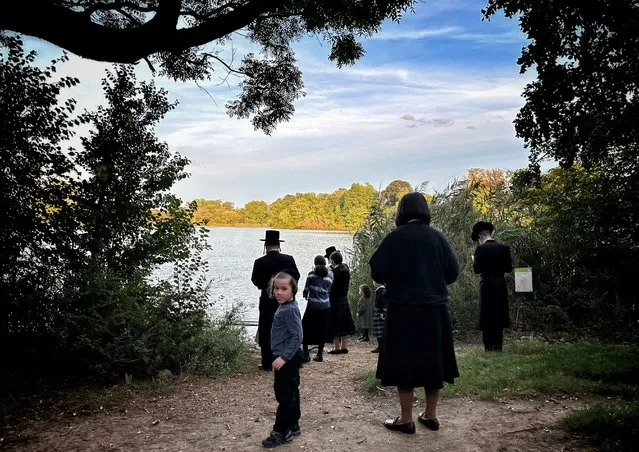 An Orthodox Jewish family pray by the lake in Prospect Park ahead of Yom Kippur, the Jewish Day of Atonement, in the Brooklyn borough of New York City, U.S., September 21, 2023. (Photo by Maye-E Wong/Reuters)