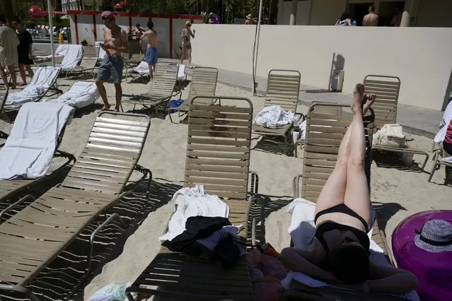 Visitor Rachel Baudek sunbathes by the pool as tourists flock to Las Vegas ahead of Memorial Day weekend at Mandalay Bay hotel and casino in Las Vegas, Nevada, U.S., May 28, 2021. (Photo by Bridget Bennett/Reuters)