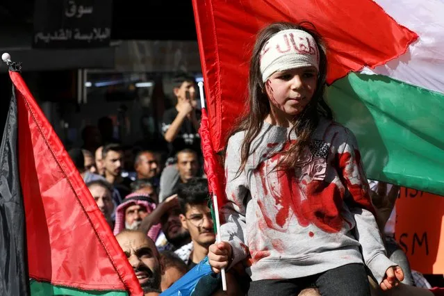 A child holds a flag as Jordanians attend a protest in support of Palestinians in Gaza, amid the ongoing conflict between Israel and the Palestinian Islamist group Hamas, in Amman, Jordan on November 3, 2023. (Photo by Alaa Al Sukhni/Reuters)