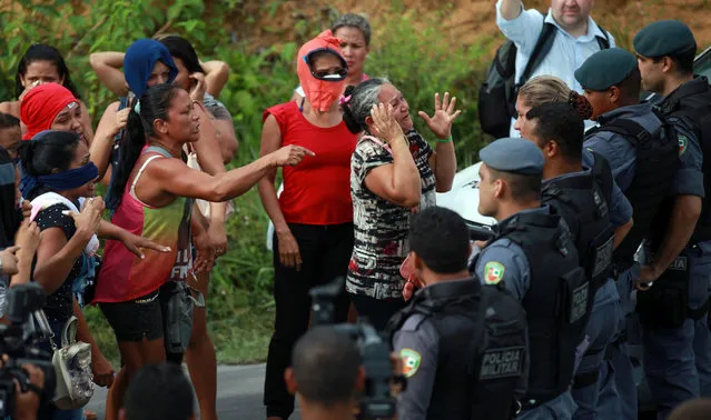 Relatives of prisoners react near riot police at a checkpoint close to the prison where around 60 people were killed in a prison riot in the Amazon jungle city of Manaus, Brazil, January 2, 2017. (Photo by Michael Dantas/Reuters)