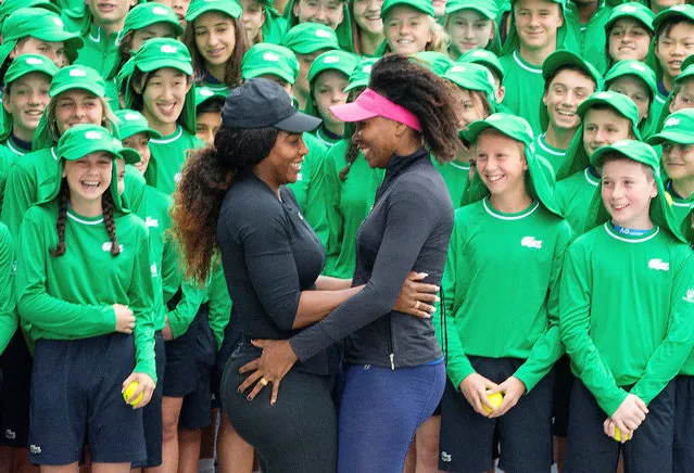 Serena and Venus Williams of the U.S. stand together with Australian Open tennis tournament ballboys and girls during a promotional event at Melbourne Park, Australia, in this handout image taken January 10, 2017. (Photo by Fiona Hamilton/Reuters/Tennis Australia)