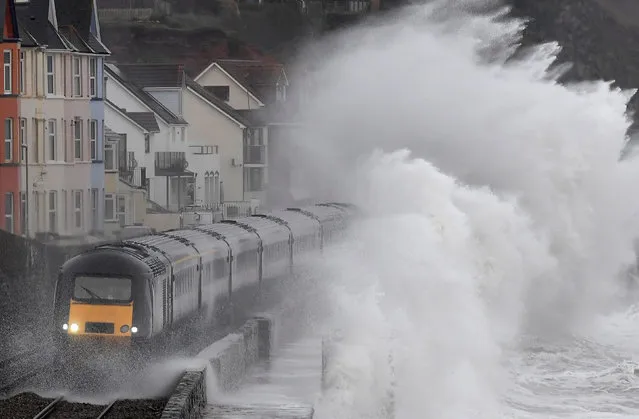 Large waves crash over a train as it passes through Dawlish in southwest Britain, January 31, 2019. (Photo by Toby Melville/Reuters)