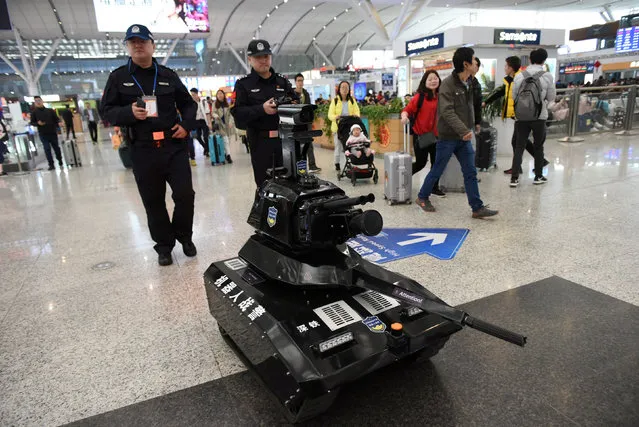 Police officers operate a security robot to patrol inside a railway station as the annual Spring Festival travel rush starts ahead of the Chinese Lunar New Year, in Shenzhen, Guangdong province, China January 21, 2019. (Photo by Reuters/China Stringer Network)