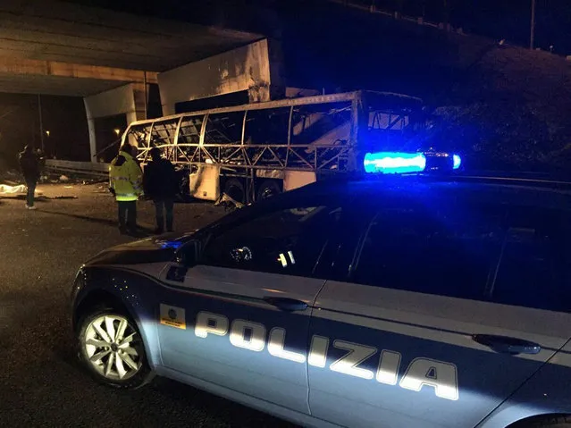 A police car is parked next to a bus that crashed along the A4 highway near Verona, Italy, Saturday, January 21, 2017. Police say 16 people have died when a bus of Hungarian school students returning home from France crashed into the side of a highway near Verona. The bus was returning to Budapest with students ages 15 to 17, thirty-nine people survived. (Photo by ANSA via AP Photo)