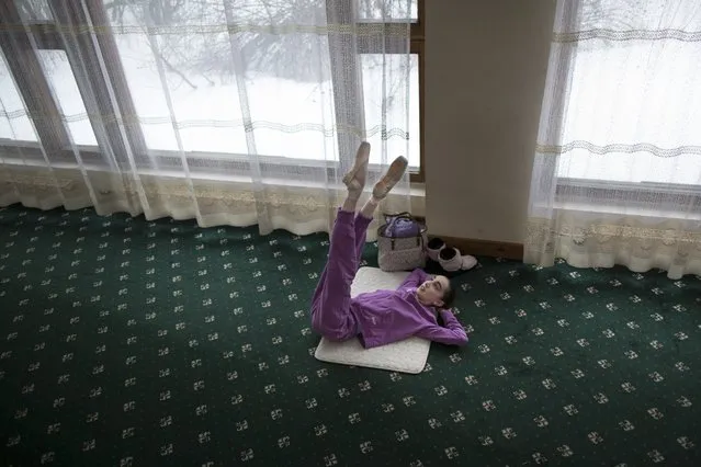 In this photo taken on Thursday, March  3, 2016, Harper Ortlieb, from Mount Hood, Oregon, stretches in a ballet class at the Bolshoi Ballet Academy in Moscow, Russia. (Photo by Alexander Zemlianichenko/AP Photo)