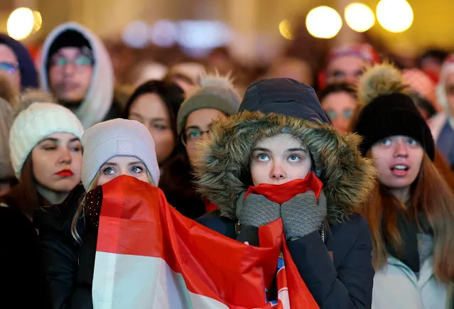 Croatia fans watch from the Ban Josip Jelacic Square in Zagreb, Croatia, as Argentina's Julian Alvarez scores the team's second goal during a World Cup semifinal football match in Qatar on December 13, 2022. (Photo by Antonio Bronic/Reuters)