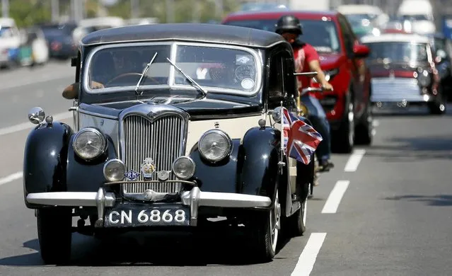 A participant drives a Riley classic car during a rally as part of the annual “British Car Day” celebrations in Colombo, Sri Lanka March 13, 2016. (Photo by Dinuka Liyanawatte/Reuters)