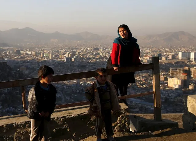 A girl holds onto a railing overlooking Kabul city, Afghanistan January 31, 2016. (Photo by Ahmad Masood/Reuters)
