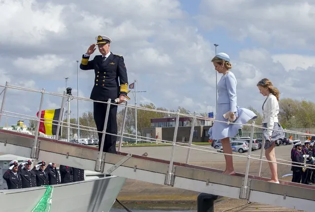 Belgium's King Philippe gives a salute while Queen Mathilde and Princess Elisabeth (foreground, L-R) wait during the launching of the new Belgian navy patrol ship P902 Pollux in Zeebrugge May 6, 2015. Princess Elisabeth accepted a request to become the godmother of the vessel. (Photo by Yves Herman/Reuters)