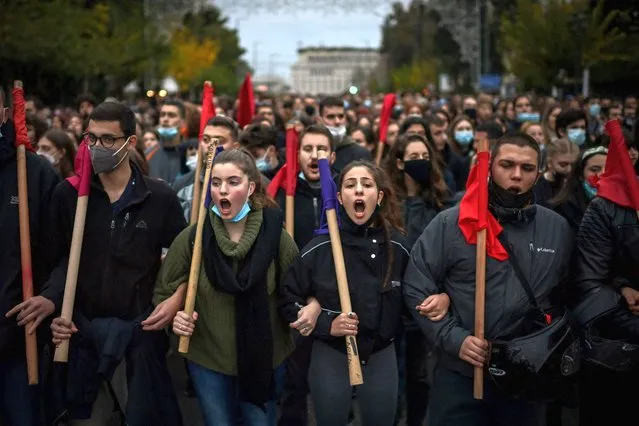 Demonstrators take part in a march towards the US embassy, during a rally marking the 48th anniversary of the 1973 Athens Polytechnic uprising against the military junta, in Athens on November 17, 2021. More than 5000 police were deployed to secure the massive march. (Photo by Aris Messinis/AFP Photo)