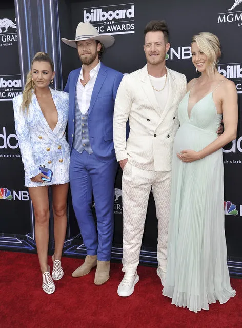 Brittney Marie Cole, from left, Brian Kelley and Tyler Hubbard, of Florida Georgia Line, and Hayley Stommel arrive at the Billboard Music Awards on Wednesday, May 1, 2019, at the MGM Grand Garden Arena in Las Vegas. (Photo by Richard Shotwell/Invision/AP Photo)