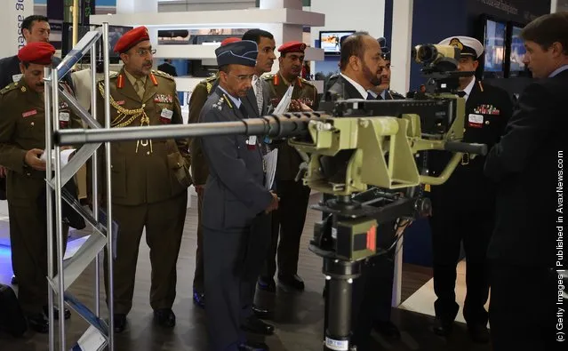 Members of Oman's military look at weapons at The Defence and Security Exhibition