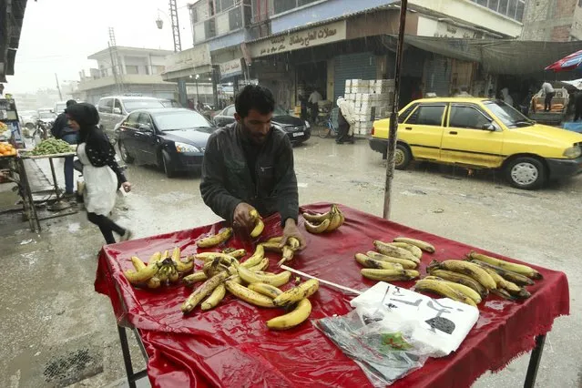 A vendor arranges bananas in a vegetable market in Qamishli, Syria April 11, 2016. (Photo by Rodi Said/Reuters)