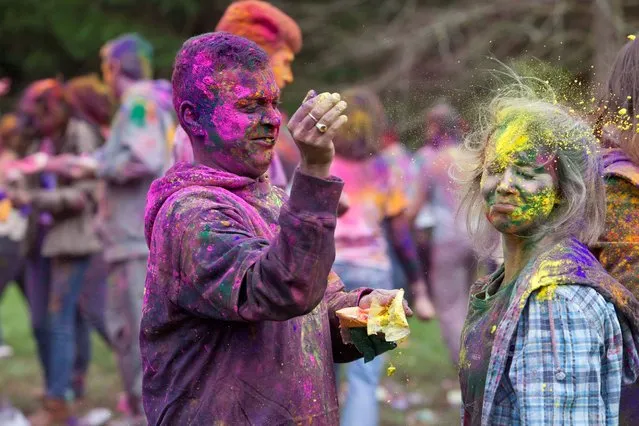 Shelly Conroy, UCC student joins with the UCC Indian Society as they celebrate the Holi Festival an Indian spring festival also known as the festival of colours and the festival of love, at the grounds of the Lewis Glucksman Gallery, University College Cork, on March 22, 2014. (Photo by Clare Keogh/PA Wire)