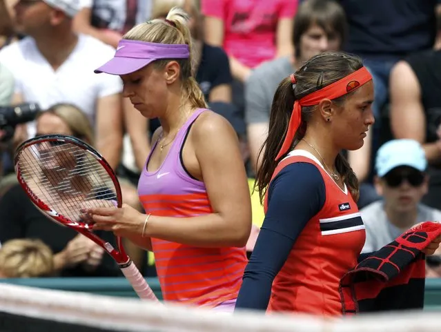 Monica Puig (R) of Puerto Rico and Sabine Lisicki of Germany walk on the court during their women's singles match at the French Open tennis tournament at the Roland Garros stadium in Paris, France, May 25, 2015. (Photo by Pascal Rossignol/Reuters)