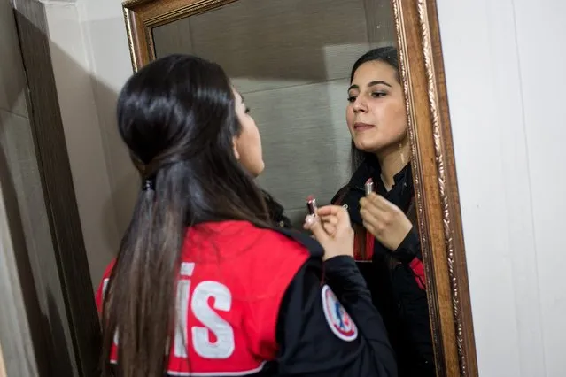 A female police officer from Istanbul's Motorcycled Police Unit puts on lipstick before heading out on patrol on March 7, 2017 in Istanbul, Turkey. (Photo by Chris McGrath/Getty Images)