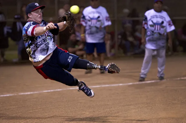 Josh Wege, Wounded Warrior Amputee Softball Team, attempts to throw out a runner during an exhibition game against Hawaii celebrities, January 11, 2013, at Central Oahu Regional Park, Waipahu, Hawaii. The Hawaii celebrities beat the Warriors 26-16. The WWAST is comprised of competitive, athletic veterans and active duty servicemembers who have lost limbs during post-9/11 combat operations. The team includes individuals with a variety of amputations of the arm, above knee, below knee, bilateral below knee and foot. (Photo by Mike Meares/647th Air Base Group)