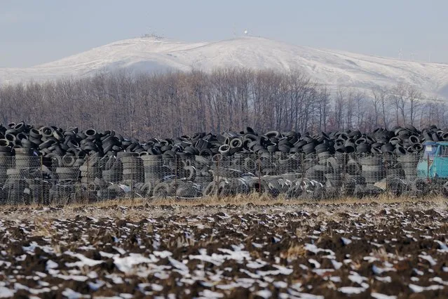 A view of piles of old tyres in the village of Magure, Kosovo, 01 December 2021. Many cities in Kosovo suffer from poor air quality, significantly exceeding the national and European Union (EU) standards and global air quality guidelines for PM2.5 established by the World Health Organization (WHO). (Photo by Valdrin Xhemaj/EPA/EFE)