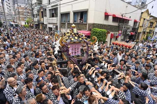 Japanese people from the Asakusa district participate in one of the most important religious processions in the capital of Japan in order to get the benevolence, blessing and prosperity of their district and its region on May 19, 2024, in Tokyo, Japan. (Photo by David Mareuil/Anadolu via Getty Images)