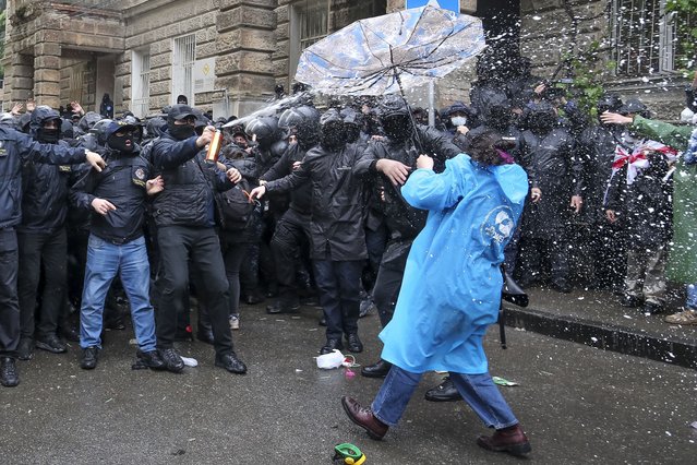 Police use a spray trying to block demonstrators near the Parliament building during an opposition protest against “the Russian law” in the center of Tbilisi, Georgia, on Monday, May 13, 2024. Daily protests are continuing against a proposed bill that critics say would stifle media freedom and obstruct the country's bid to join the European Union. (Photo by Zurab Tsertsvadze/AP Photo)