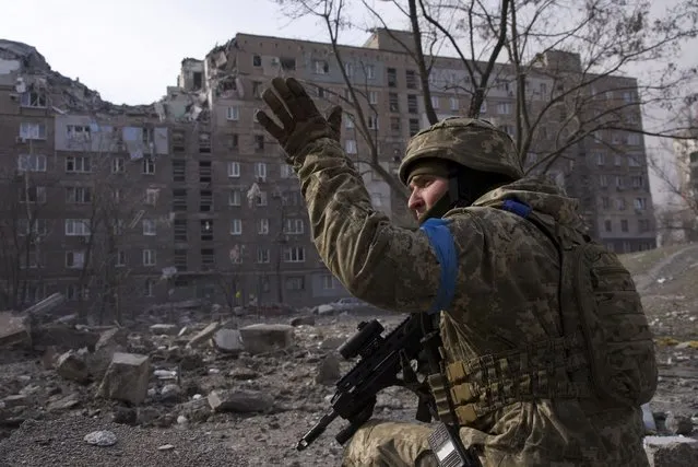 A Ukrainian serviceman guards his position in Mariupol, Ukraine, Saturday, March 12, 2022. (Photo by Mstyslav Chernov/AP Photo)