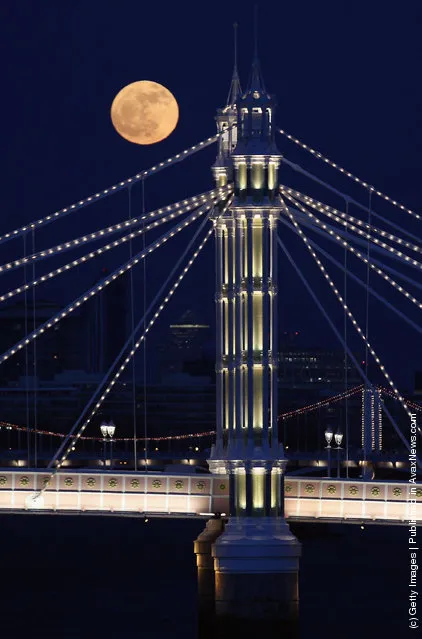 Full Moon Rises Over Albert Bridge In London
