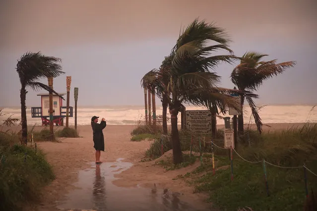 A woman takes a picture as the effects of Hurricane Dorian begin to be felt on September 2, 2019 in Cocoa Beach, Fla. (Photo by Scott Olson/Getty Images)