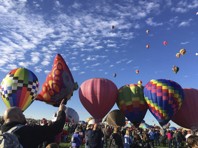 In this October 1, 2016 photo, visitors at the Albuquerque International Balloon Fiesta in Albuquerque, N.M. watch as balloons launch. New Mexico Gov. Susana Martinez unveiled “record-breaking” state tourism figures at the Albuquerque International Balloon Museum on Wednesday, July 5, 2017. (Photo by Russell Contreras/AP Photo)
