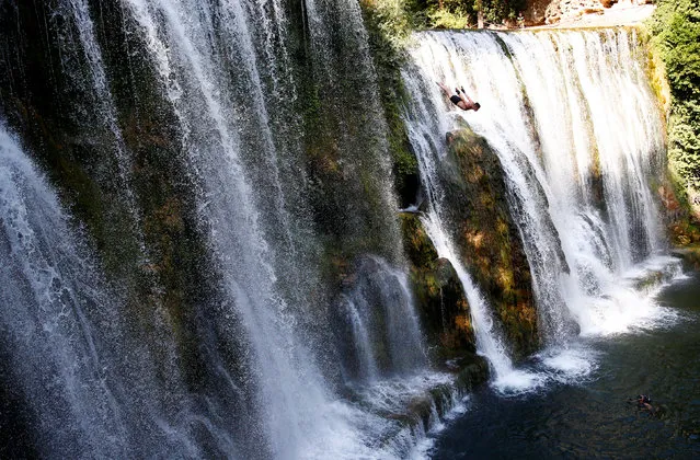 A competitor takes part in the annual international waterfall jumping competition held in the old town of Jajce, Bosnia and Herzegovina, August 5, 2017. (Photo by Dado Ruvic/Reuters)