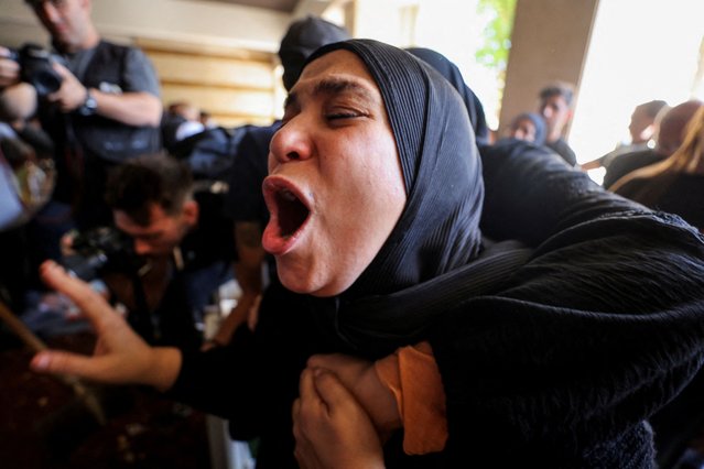 A woman mourns during the funeral of Ghassan Najjar, a cameraman at Al Mayadeen news outlet who was killed in an Israeli strike with two other journalists in the southern Lebanese town of Hasbaya, in Beirut’s southern suburbs, Lebanon on October 26, 2024. (Photo by Mohamed Abd El Ghany/Reuters)