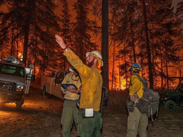 Firefighters prepare to battle the Wolverine wildfire near Chelan, Washington, in this U.S. Forest Service picture taken August 16, 2015. Wildfires have destroyed 50 homes in north central Idaho while a fire in north-central Washington nearly doubled in size, almost encircling the town of Chelan and forcing the evacuation of some 1,500. (Photo by Reuters/US Forest Service)
