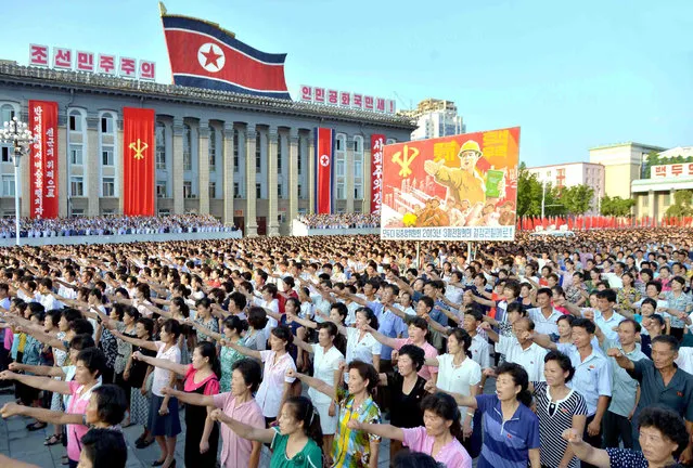 People participate in a Pyongyang city mass rally held at Kim Il Sung Square on August 9, 2017, to fully support the statement of the Democratic People's Republic of Korea (DPRK) government in this photo released on August 10, 2017 by North Korea's Korean Central News Agency (KCNA) in Pyongyang. (Photo by Reuters/KCNA)